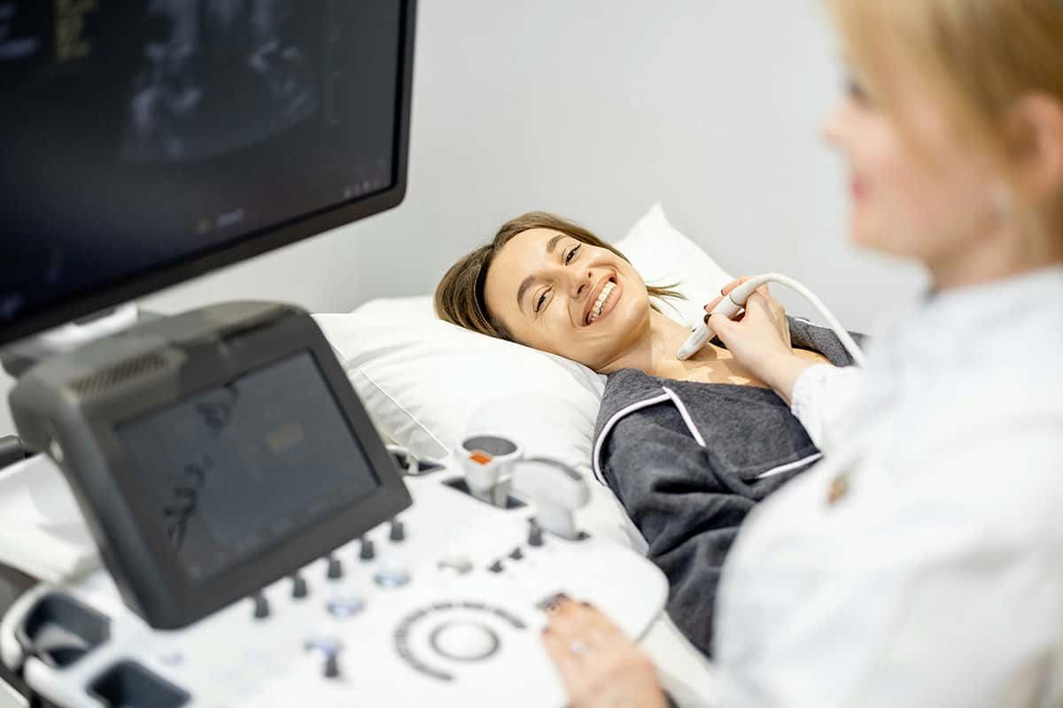 woman smiling having a chest ultrasound